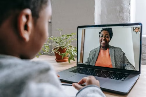 A student on a video call with a mentor